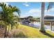 Beautifully landscaped dock with boat lift, offering easy access to the water and scenic waterfront views at 15578 Seafoam Cir, Port Charlotte, FL 33981