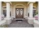 Close-up of a home's front entrance with decorative double doors, welcoming decor, and tiled porch at 15578 Seafoam Cir, Port Charlotte, FL 33981