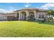 Well-maintained front yard with a beautiful lawn, decorative plants, and a charming home exterior at 15578 Seafoam Cir, Port Charlotte, FL 33981