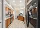Spacious kitchen featuring wood cabinetry, granite countertops, modern appliances, and wood floors at 15578 Seafoam Cir, Port Charlotte, FL 33981