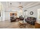 Bright living room with wood-look tile flooring and an open floor plan at 15578 Seafoam Cir, Port Charlotte, FL 33981