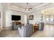 Open living room boasts a tray ceiling, recessed lights, and wood-look tile flooring at 15578 Seafoam Cir, Port Charlotte, FL 33981