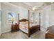 Beautiful primary bedroom suite with a ceiling fan, tray ceiling, and private access to the lanai at 15578 Seafoam Cir, Port Charlotte, FL 33981