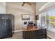 Inviting home office with a safe, large desk, and ample natural light from a large window at 15578 Seafoam Cir, Port Charlotte, FL 33981