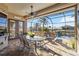 Relaxing screened-in patio with brick floors, ceiling fan, and outdoor furniture, perfect for enjoying the pool view at 15578 Seafoam Cir, Port Charlotte, FL 33981