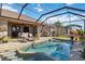 Inviting pool with spa in screened lanai, surrounded by patio and lush landscaping, creating a private oasis at 15578 Seafoam Cir, Port Charlotte, FL 33981