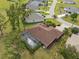 Aerial view of a single-Gathering home featuring a screened pool, landscaped yard, and nearby residential streets at 16137 Alcira Cir, Punta Gorda, FL 33955