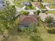 Aerial view of a single-Gathering home with a screened pool, lovely landscaping, and surrounding neighborhood homes at 16137 Alcira Cir, Punta Gorda, FL 33955