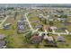 An aerial view captures a neighborhood featuring single-Gathering homes with spacious yards and tree-lined streets at 16137 Alcira Cir, Punta Gorda, FL 33955