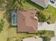 Aerial view of a single-Gathering home featuring a screened pool, beautiful landscaping, and a paved driveway at 16137 Alcira Cir, Punta Gorda, FL 33955