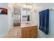 Charming bathroom with a wooden vanity, bright lighting, and a view into the adjacent main bedroom at 16137 Alcira Cir, Punta Gorda, FL 33955