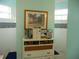 Bathroom dresser with white cabinets, wicker drawers, and a beautiful blue accent wall at 16137 Alcira Cir, Punta Gorda, FL 33955