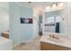 Charming bathroom with a wooden vanity, bright lighting, and a view into the adjacent main bedroom at 16137 Alcira Cir, Punta Gorda, FL 33955