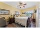 Inviting bedroom with wood floors, ceiling fan, and a serene ambiance, perfect for relaxation at 16137 Alcira Cir, Punta Gorda, FL 33955