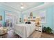 Bright bedroom with white furniture, wood floors, and plantation shutters, offering a serene and inviting space at 16137 Alcira Cir, Punta Gorda, FL 33955