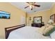 Comfortable bedroom with wood floors, a ceiling fan, and a dresser, creating a relaxing atmosphere at 16137 Alcira Cir, Punta Gorda, FL 33955