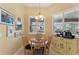 Bright breakfast nook with large windows and cafe-style seating is next to a small table with a coffee maker at 16137 Alcira Cir, Punta Gorda, FL 33955