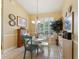 Cozy dining area with a table and chairs, a chandelier, and a window with shutter-style blinds at 16137 Alcira Cir, Punta Gorda, FL 33955