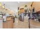 Open-concept kitchen flows into the dining and living spaces and features stainless steel appliances and modern cabinetry at 16137 Alcira Cir, Punta Gorda, FL 33955