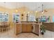 Bright kitchen features pendant lighting, stainless steel appliances, and a cozy breakfast nook, perfect for casual dining at 16137 Alcira Cir, Punta Gorda, FL 33955