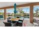 Screened lanai featuring an outdoor dining set with view of a refreshing swimming pool at 16137 Alcira Cir, Punta Gorda, FL 33955