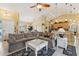 Open-concept living room showcases a large sectional couch, a coffee table, and seamless flow into the kitchen and dining area at 16137 Alcira Cir, Punta Gorda, FL 33955