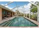 Relaxing screened-in pool with brick accents and a spacious deck with lounging and dining furniture at 16137 Alcira Cir, Punta Gorda, FL 33955