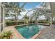 Refreshing swimming pool surrounded by a screened enclosure and lush landscaping at 16137 Alcira Cir, Punta Gorda, FL 33955