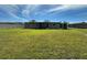 The back of the house has an expansive lawn and screened in porch at 192 Garden Nw Ave, Port Charlotte, FL 33952