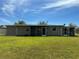 The back of the house has an expansive lawn and screened in porch at 192 Garden Nw Ave, Port Charlotte, FL 33952