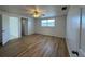 Bedroom with wood-look flooring, ceiling fan, and plenty of natural light at 192 Garden Nw Ave, Port Charlotte, FL 33952