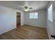 Bedroom with wood-look flooring, ceiling fan, and plenty of natural light at 192 Garden Nw Ave, Port Charlotte, FL 33952