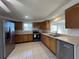 Bright kitchen features wood cabinets, stainless steel appliances, and tile flooring at 192 Garden Nw Ave, Port Charlotte, FL 33952