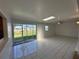 Sunroom-style living room with lots of natural light from the large glass sliding doors at 192 Garden Nw Ave, Port Charlotte, FL 33952