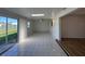Bright living room with tile floor, skylight, and sliding glass door to outside at 192 Garden Nw Ave, Port Charlotte, FL 33952