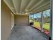 Covered back patio perfect for outdoor relaxation, complete with a ceiling fan at 192 Garden Nw Ave, Port Charlotte, FL 33952