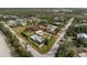 Aerial view of property surrounded by mature trees marked with red boundary lines at 2191 Williamsburg Way, Englewood, FL 34224