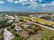 Aerial view of property highlighted with a red boundary line in a neighborhood near a pond at 2191 Williamsburg Way, Englewood, FL 34224