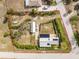Aerial view of a property with a defined boundary, including a home with solar panels and a detached garage at 2191 Williamsburg Way, Englewood, FL 34224