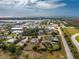 Wide aerial view of a property with a defined boundary, including a home, outbuilding and mature landscaping at 2191 Williamsburg Way, Englewood, FL 34224