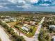 Aerial view of a property with a defined boundary, including a home, outbuilding and mature landscaping at 2191 Williamsburg Way, Englewood, FL 34224