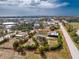 Wide aerial view of a property with a defined boundary, including a home, outbuilding and mature landscaping at 2191 Williamsburg Way, Englewood, FL 34224