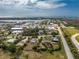 An aerial view of a property in a coastal town with a nearby harbor and beautiful waterways at 2191 Williamsburg Way, Englewood, FL 34224