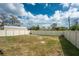 Spacious backyard features a white fence, offering privacy and security at 2191 Williamsburg Way, Englewood, FL 34224