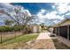 Landscaped backyard with a shed, paver patio, and fenced perimeter at 2191 Williamsburg Way, Englewood, FL 34224