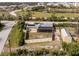 Aerial view of backyard with solar panels, a fenced yard and detached garage at 2191 Williamsburg Way, Englewood, FL 34224
