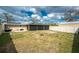Large backyard with an enclosed porch, ready for outdoor activities at 2191 Williamsburg Way, Englewood, FL 34224