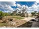 Backyard with rock seating around a fire pit and convenient storage shed at 2191 Williamsburg Way, Englewood, FL 34224