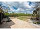 Outdoor space featuring a patio area with seating and lush greenery at 2191 Williamsburg Way, Englewood, FL 34224