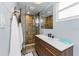Modern bathroom featuring a stylish vanity, a glass-enclosed shower, and neutral-toned tile work at 2191 Williamsburg Way, Englewood, FL 34224
